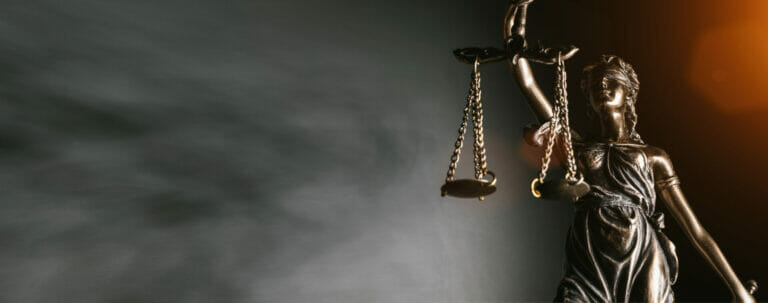 Statue of lady justice on bright background - Side view with cop