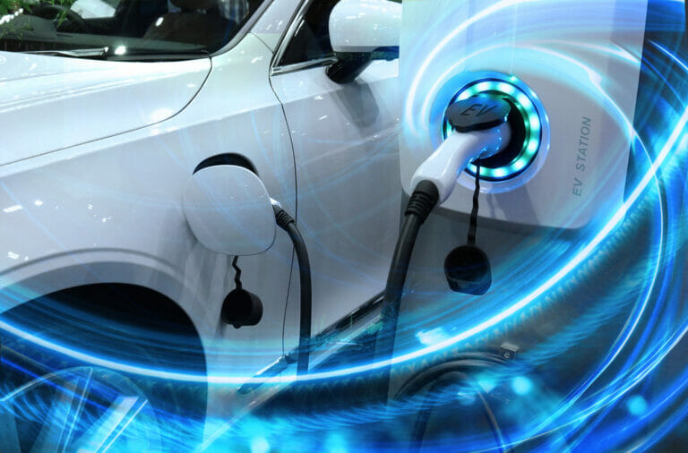 EV Car or Electric vehicle at charging station with the power cable supply plugged in on blurred nature with blue energy power effect. Eco-friendly sustainable energy concept