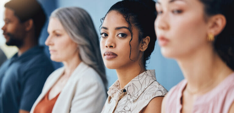Training, learning and education with a business woman looking serious and sitting in a conference or workshop for coaching